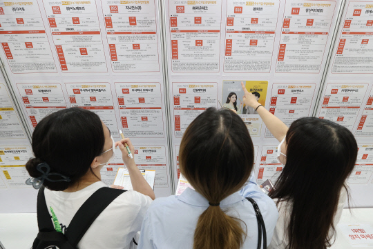 5월= 22일 오전 서울 강남구 코엑스에서 열린 '2023 제1차 KB굿잡 우수기업 취업박람회'에서 취업준비생들이 채용공고를 살펴보고 있다. <연합뉴스>